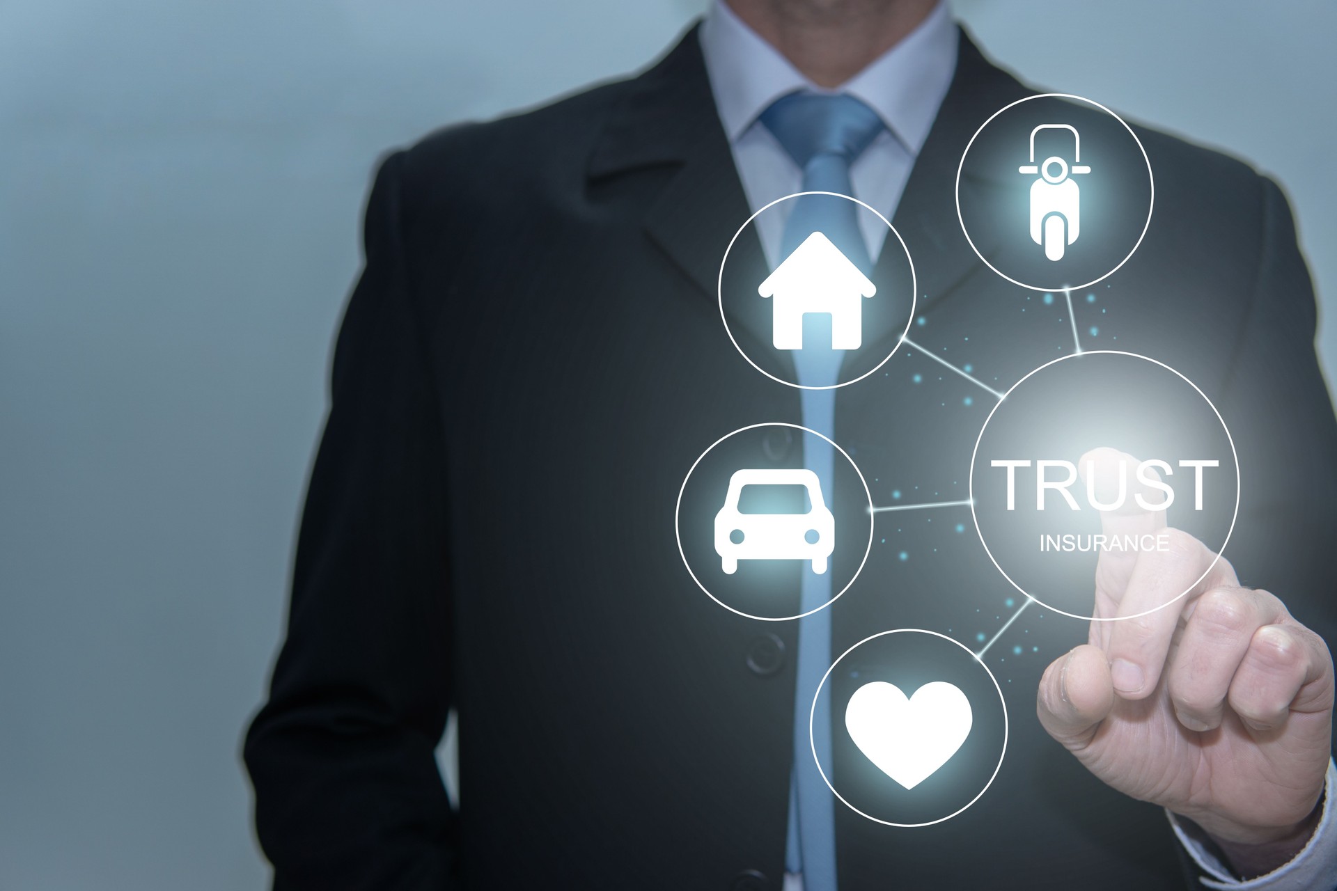 Businessman touching trust icon. Life, house, car and motorcicle insurance. Family protection concept.